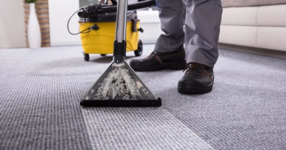 Canva - Person Cleaning Carpet With Vacuum Cleaner-min